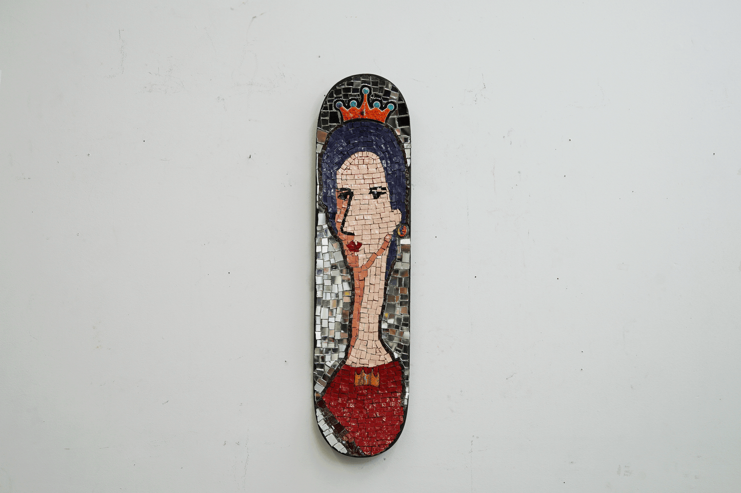 skateboard mosaic portrait of a woman with elongated face with a crown and red dress