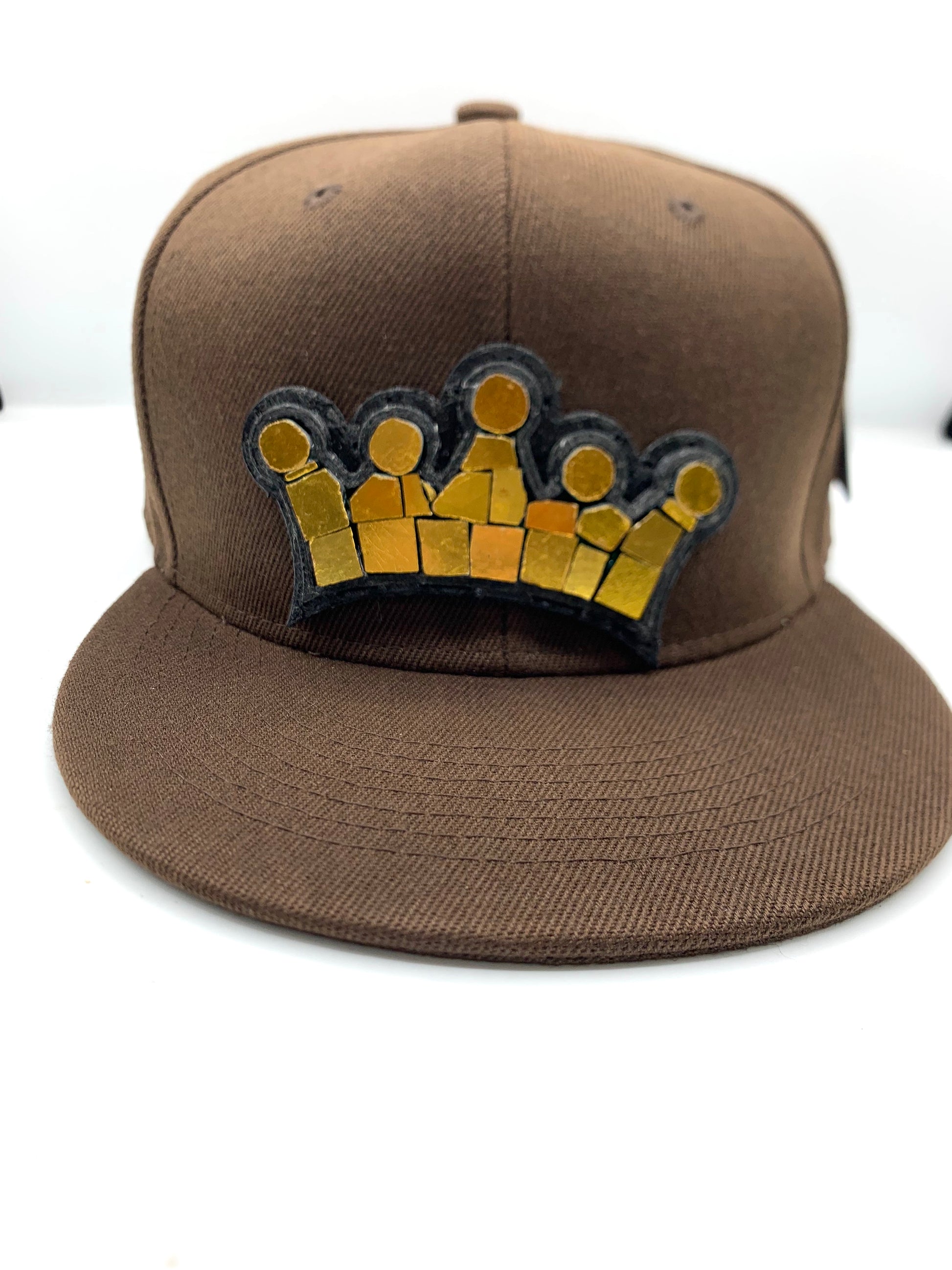 brown baseball hat with a 18 karat gold crown