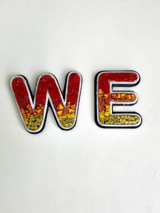 letters w and E with micro mosaic in yellow and orange