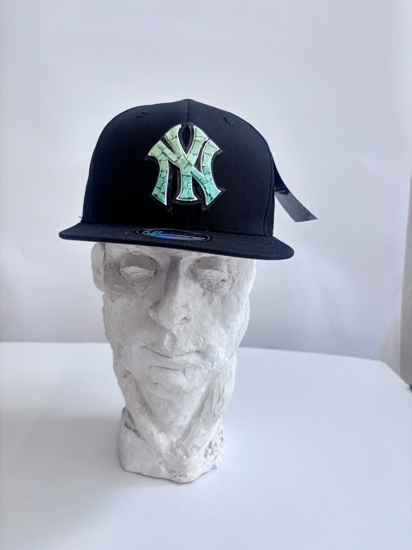 Six panel black baseball cap with Blue Yankees Glass Micro mosaic logo.