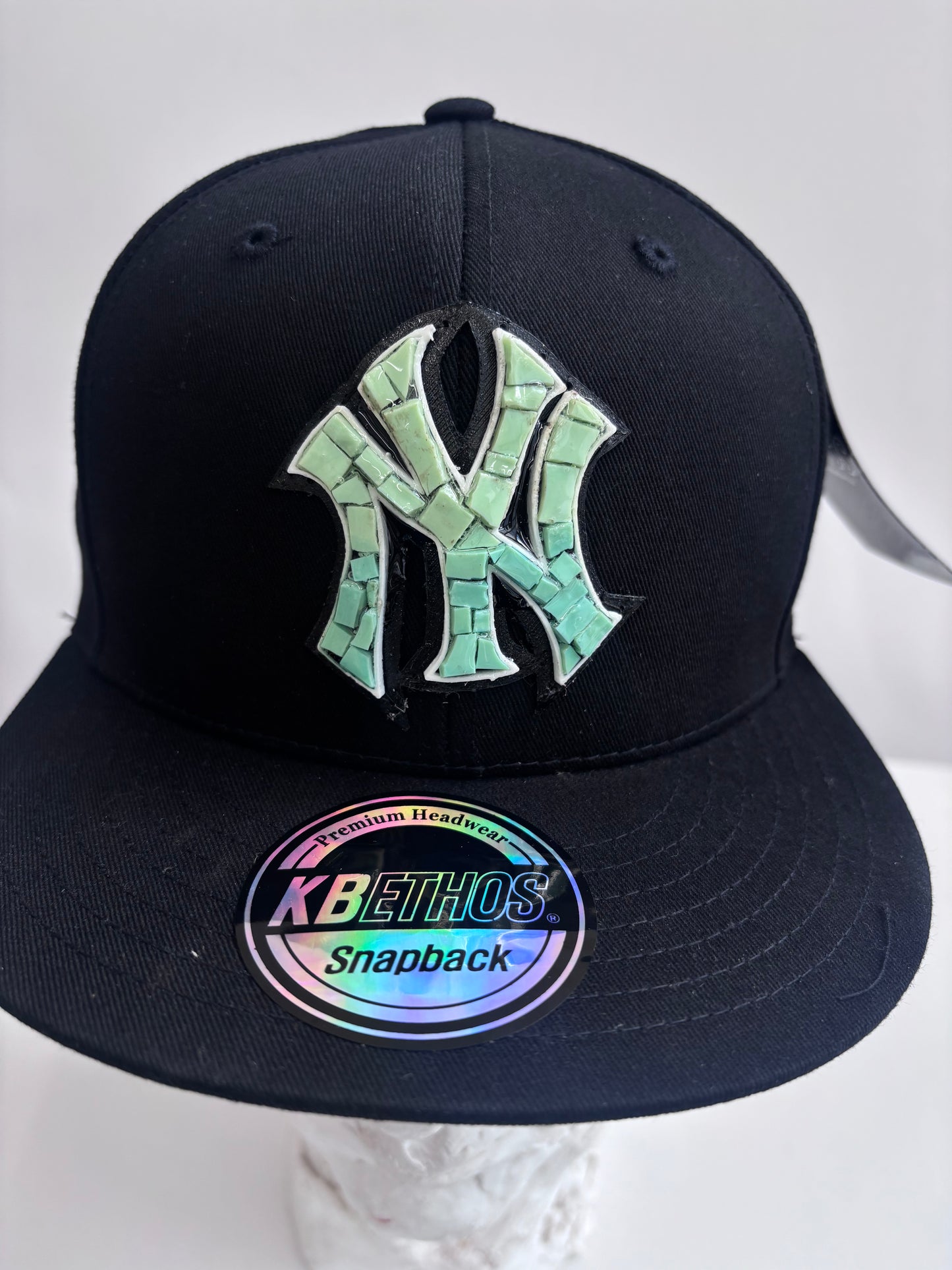 Six panel black baseball cap with Blue Yankees Glass Micro mosaic logo.