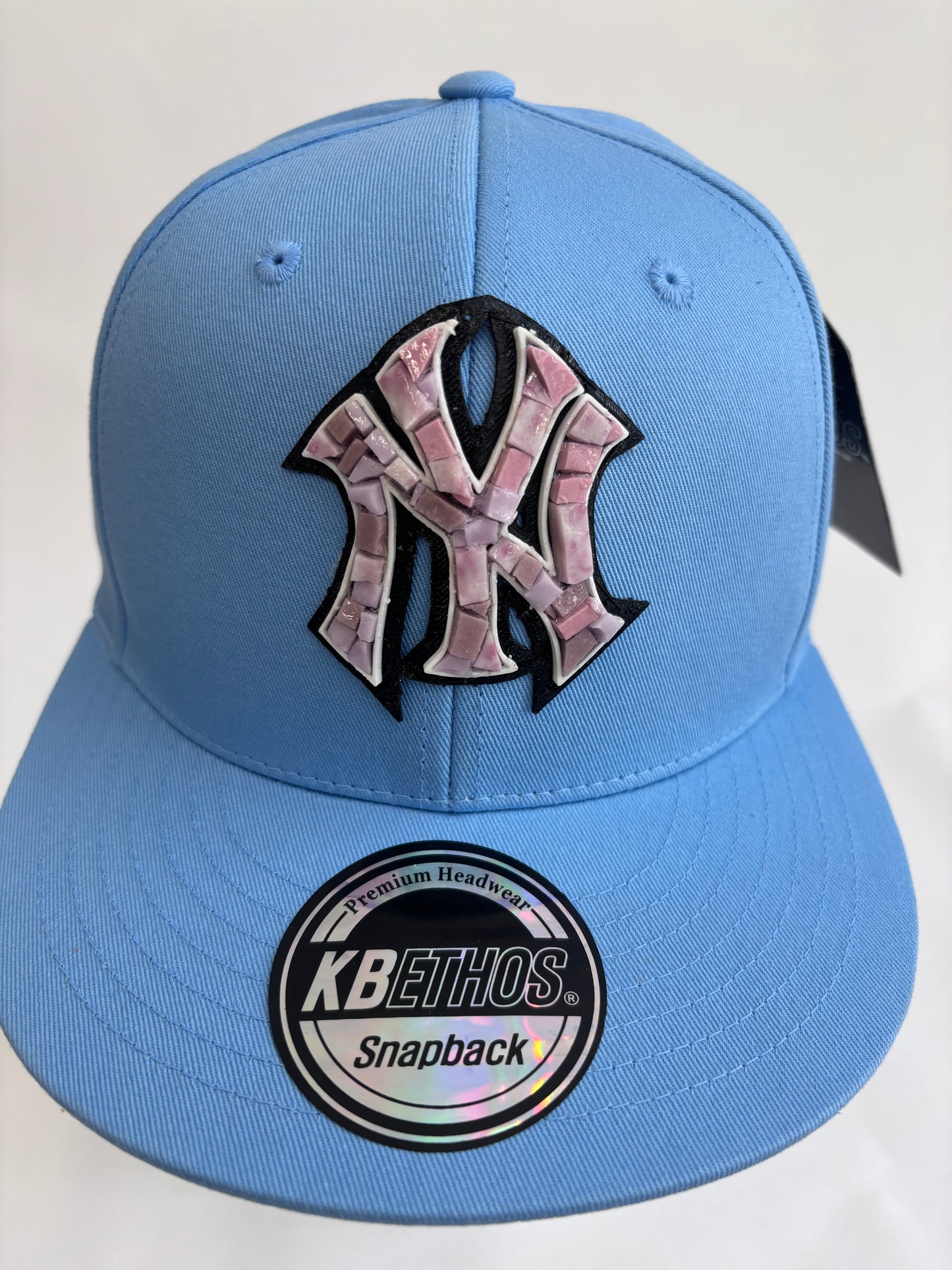 six panel light blue baseball cap with lilac micro mosaic logo