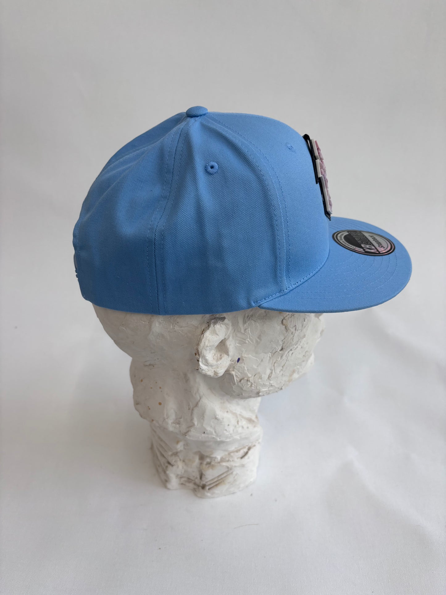 six panel light blue baseball cap with lilac micro mosaic logo