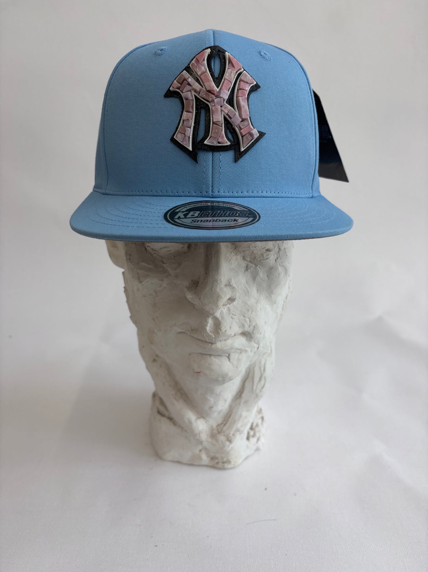 six panel light blue baseball cap with lilac micro mosaic logo
