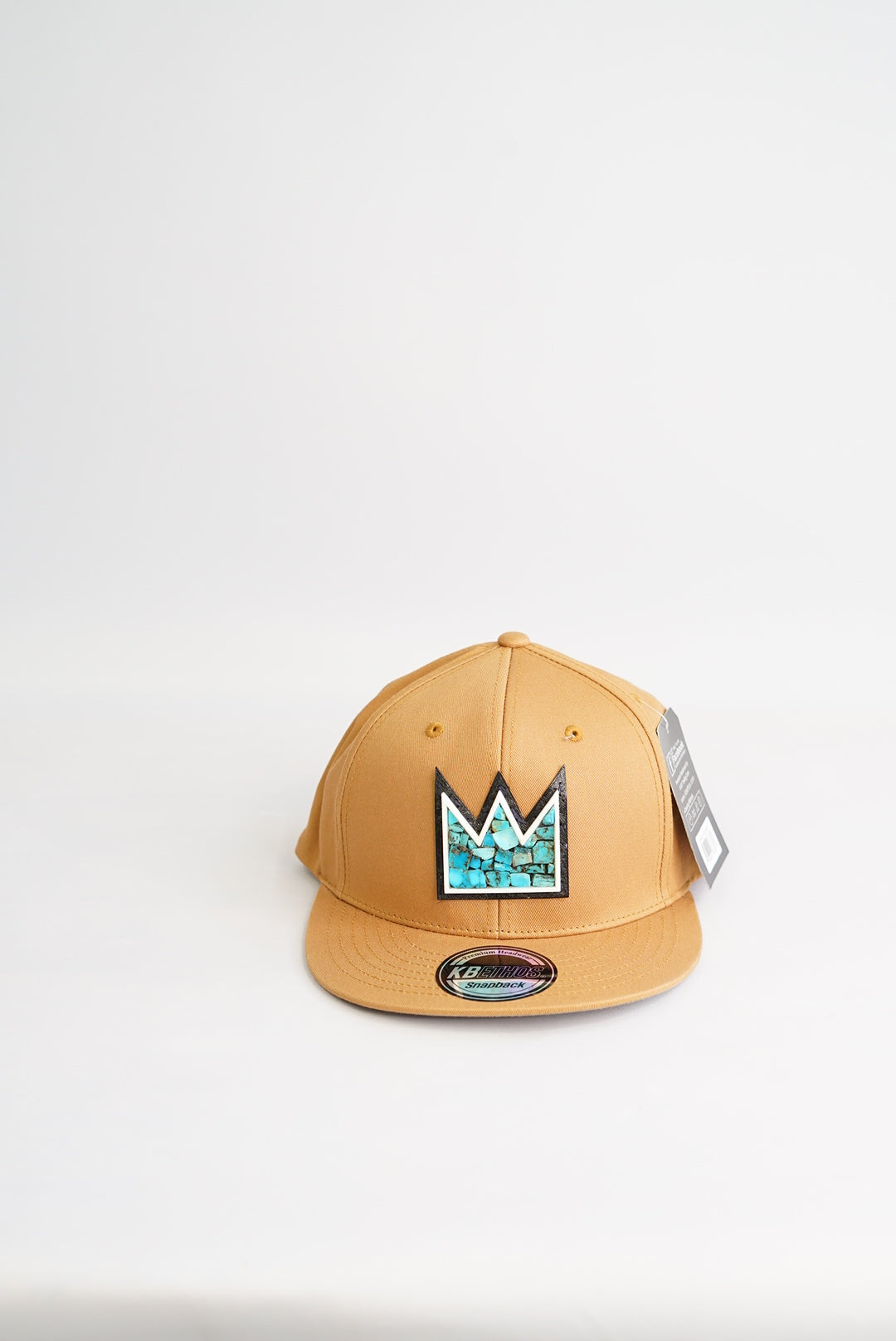 close up light brown baseball cap with Turquoise Crown Mosaic