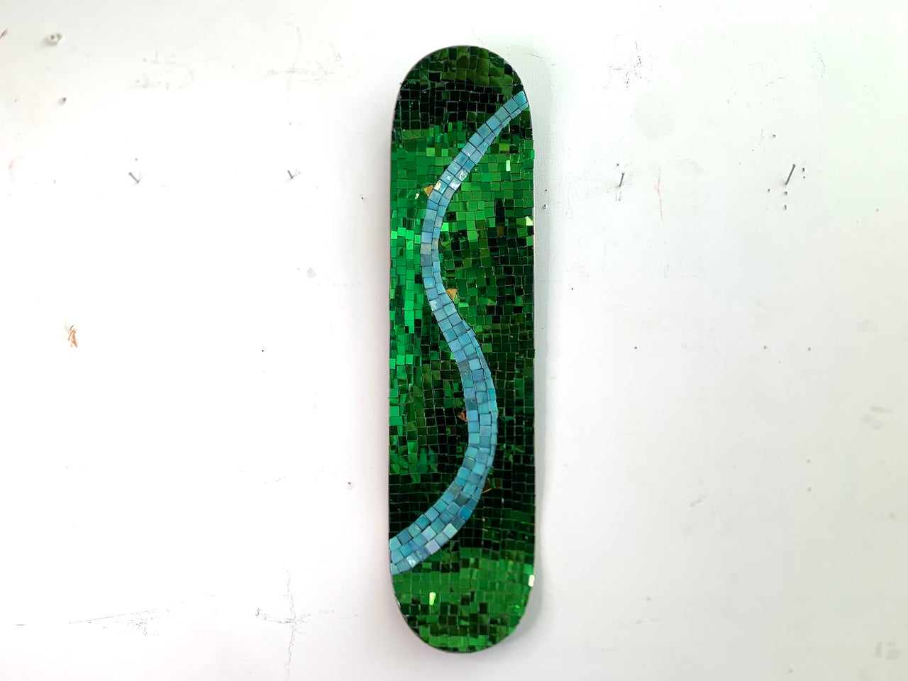 Green Thai mirror glass  skateboard deck depicting spring  Edit alt text